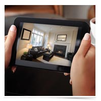 Image of woman monitoring home on iPad.