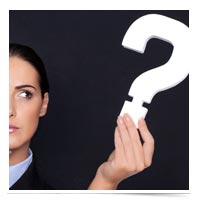 Image of woman holding question mark.