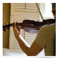 Image of girl practicing violin.