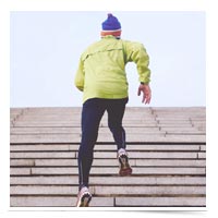 Man running stadium stairs.