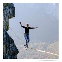 Woman walking tightrope.