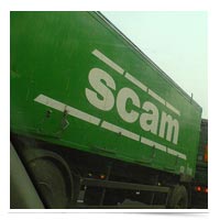 Truck with scam written on the side.