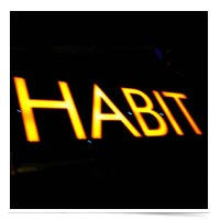 Image of word HABIT in neon.