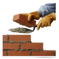 Image of hands laying bricks.