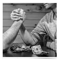 Men arm wrestling over money