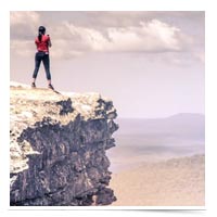 Woman at the top of a mountain.