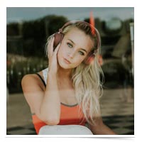 Young blonde girl with headphones on.