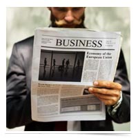 Man reading business section of newspaper.