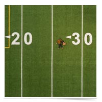 Man lying down on 30-yard line.