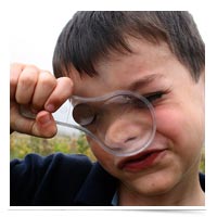 Kid with magnifying glass.